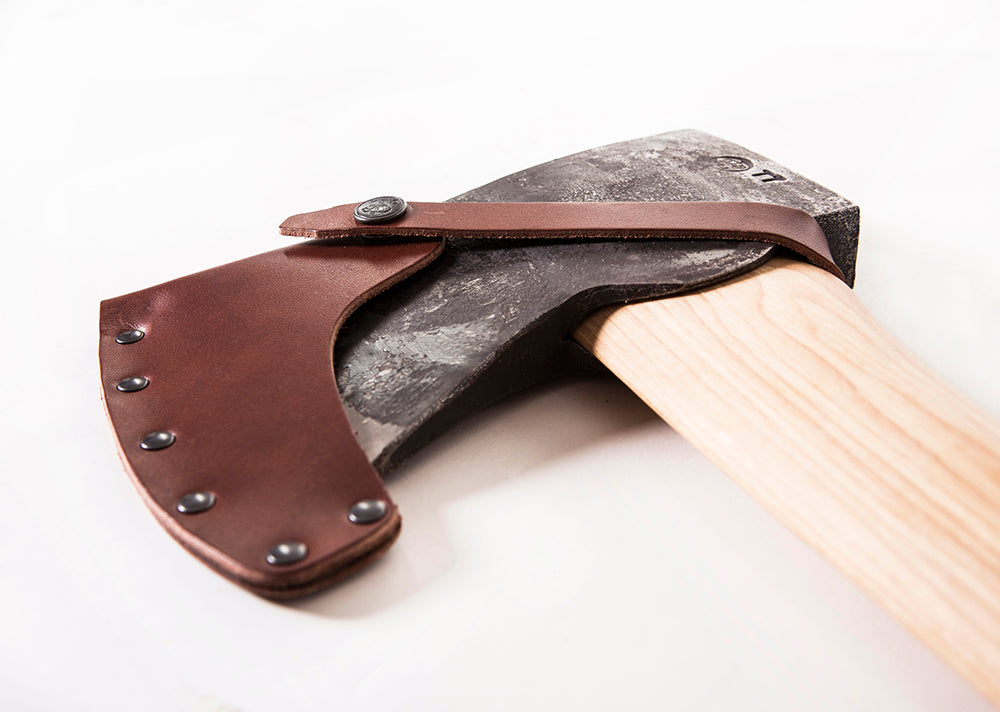 Axe with leather sheath on a white background