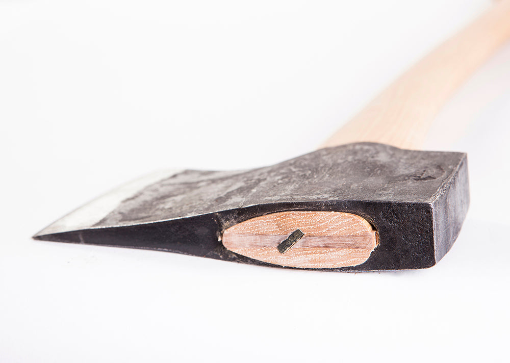 Close-up of a axe with a wooden handle on a white background