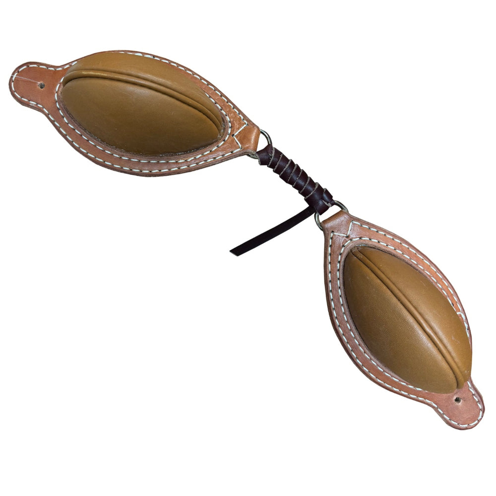 A pair of brown leather saddle bucking rolls with stitching and a strap, crafted by McCall Saddle Company.
