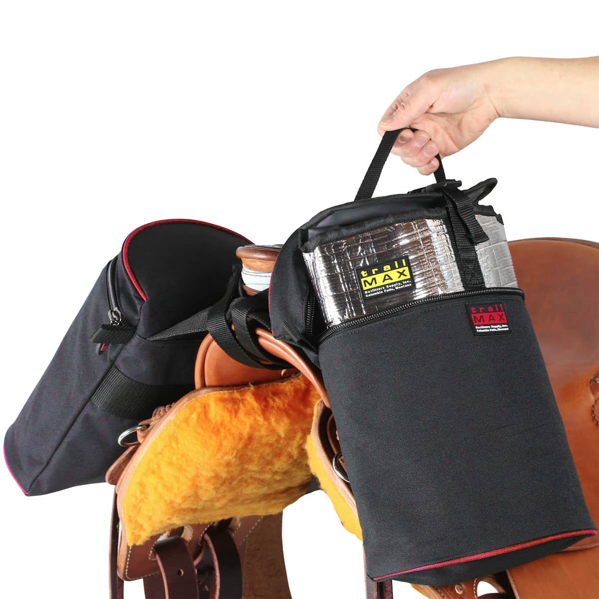 Set of large horn bags on riding saddle with person removing the Grab-and-Go liner from one side.