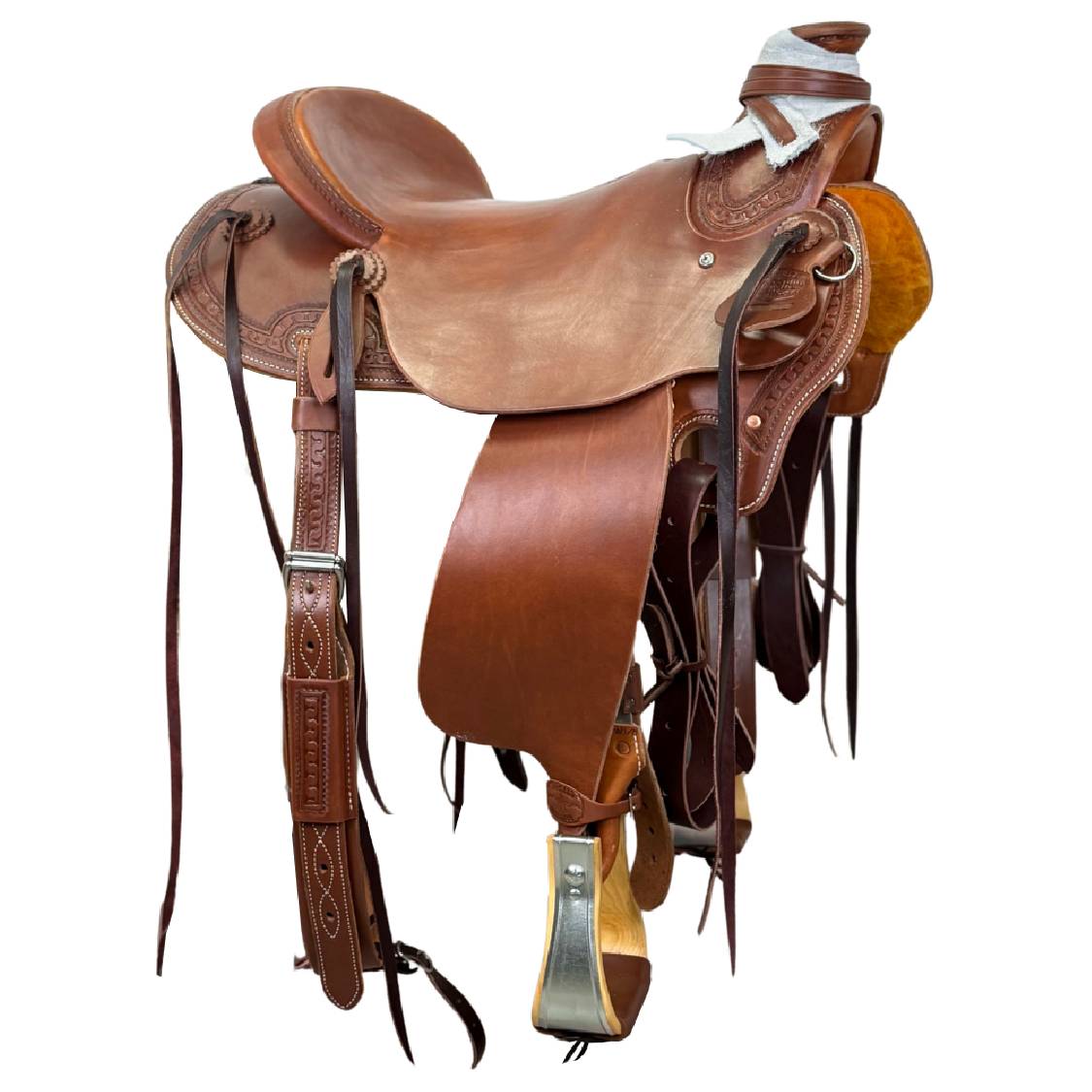 A brown leather western saddle photographed on a plain white background.