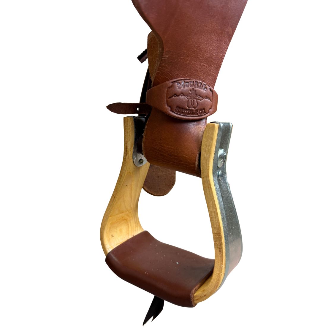 A close-up of a Western-style stirrup with dark brown leather straps and a light natural wood inner frame, featuring a metal outer frame and a leather brand patch that reads 'Yerka Western Co.' on a white background.